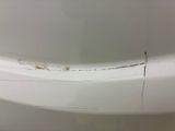 a close up of a white bath tub with a rusted edge