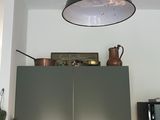 a picture of a kitchen with a large light above it