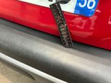 a ruler attached to the back of a red car