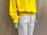 a mannequin mannequin wearing a yellow hoodie and white pants
