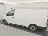 a white van parked in a garage with a ladder on the roof