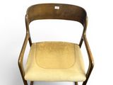 a wooden chair with a yellow seat and a white background