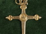 an image of a cross on a green velvet surface