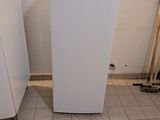 an image of a white refrigerator in the corner of a room