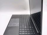 a laptop with a black keyboard on a white surface