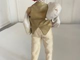 a figurine of a man holding a sheep in his arms