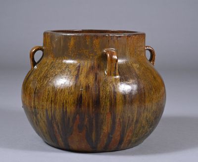 brown vase with handles and handles on a gray background