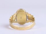 an image of a close up of a gold ring on a white surface