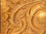 an image of a gold plate with a decorative design on it