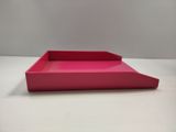 a pink tray sitting on top of a white table