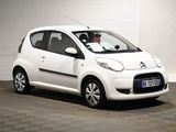 a picture of a small white car parked in a garage