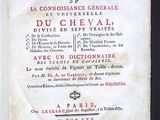 an old book with a black cover and red writing on it