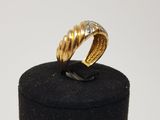 an image of a gold and diamond ring sitting on top of a black box