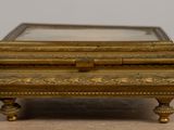 an antique brass box with a mirror on top of it