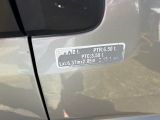 a sticker on the side of a car that is parked in the street