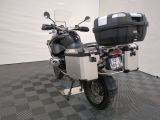 a motorcycle parked in a room with a black and white checkered floor