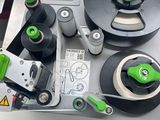 a machine that is sitting on a table with a green handle