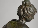 bronze statue of a young boy with a bird on his shoulder