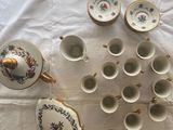 many cups and saucers sitting on a table