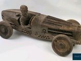 a wooden toy car with a man in it