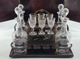 bottles and glasses on a wooden tray with a mirror in the background
