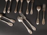 many forks and spoons laid out on a table