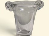 a glass vase that has a handle on it