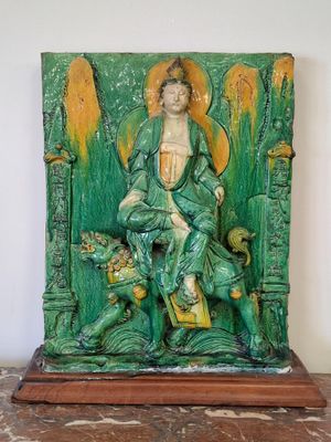 a statue of a man sitting on top of a table