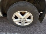 the tire of a white car with a flat tire on a parking lot