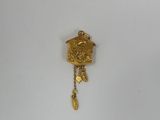 an image of a gold cuckoo clock hanging on a white wall