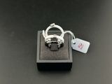 un gros plan d'une bague posée sur une boîte noire, avec une étiquette de prix