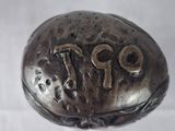 a small silver object with numbers on it on a white surface