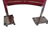 an image of a red curved desk with wheels