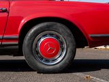 an image of a red car parked in a parking lot