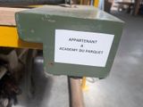 a sign on the back of a machine in a warehouse