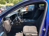 the interior of a blue car with the driver ' s seat up