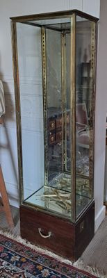 une vitrine en verre dans le coin d'une pièce