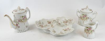 une table blanche avec une théière, un bol et une théière