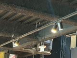 many lights that are hanging from the ceiling of a building