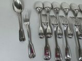 a lot of spoons and forks sitting on a table