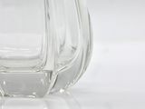 a clear glass vase sitting on a white surface