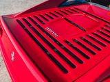 a close up of the hood of a red sports car