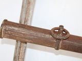 an old rusty pipe with a metal ring on it