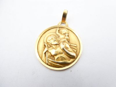 a close up of a gold medal with a woman holding a child