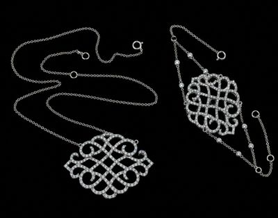 two pieces of silver jewelry are shown on a black background
