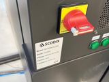 a close up of a machine with a red button