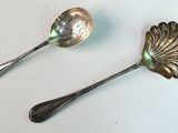 two spoons sitting next to each other on a table