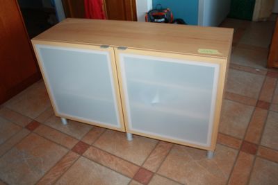 a small cabinet with two doors on the floor