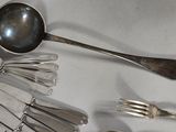 a lot of spoons and forks on the table
