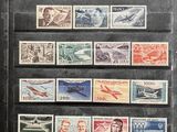 an old picture of a collection of stamps on display in a glass case
